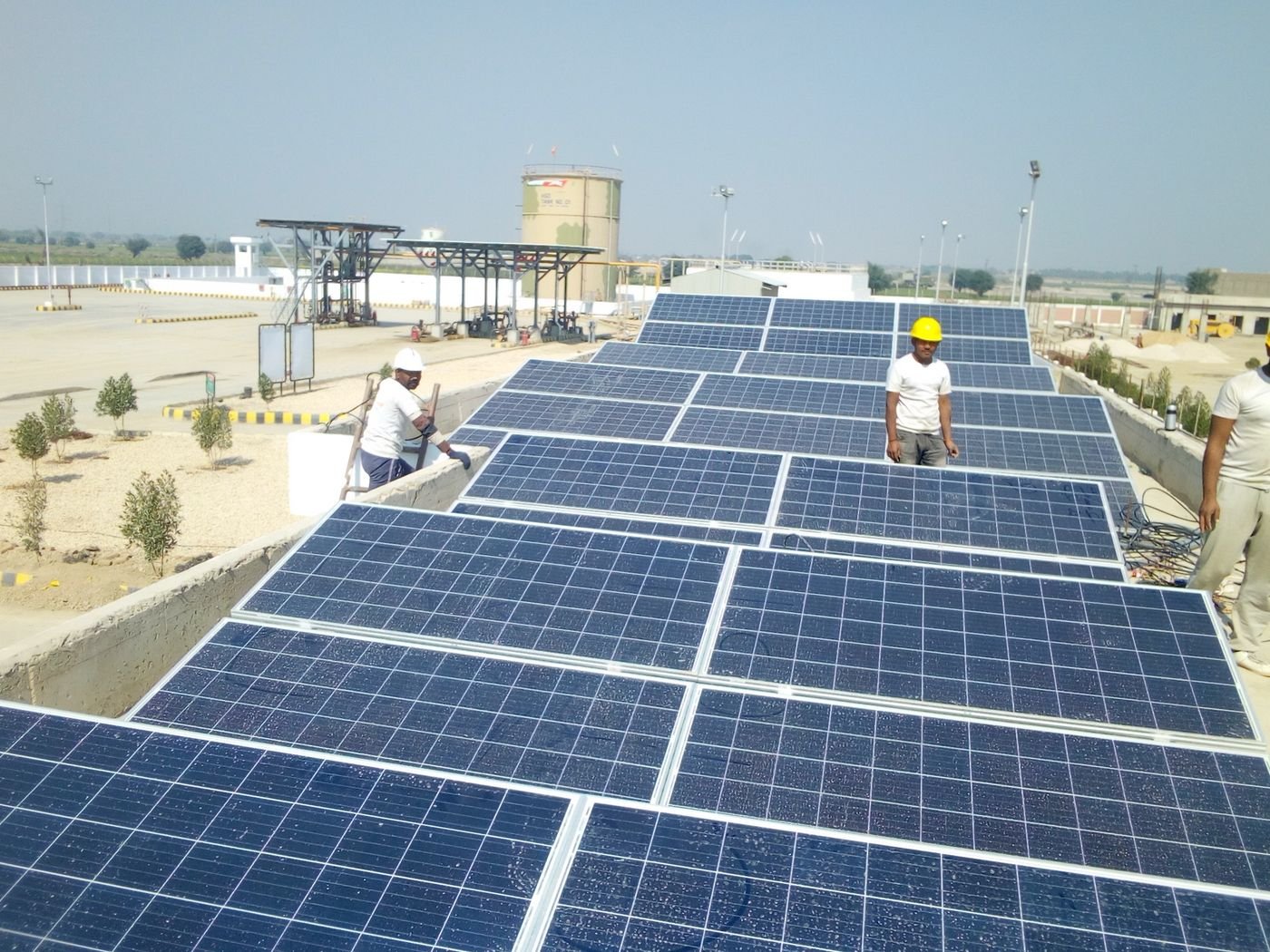 Workers installing solar panels on a house rooftop