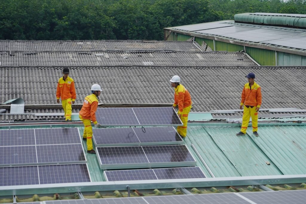 Workers installing rooftop solar panels